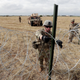 Above and below, members of a US Army engineering brigade place concertina wire around an encampment for troops, Department of Defense and Customs and Border Protection personnel near the U.S.-Mexico International bridge on Nov. 4. in Donna, Texas.